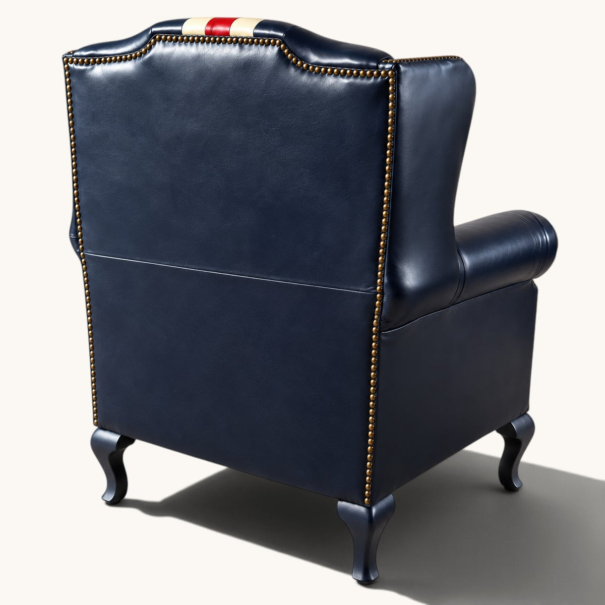 The Britannia Union Jack Chesterfield wingback armchair in genuine buffalo leather, featuring a hand-painted British flag, deep button tufting and brass studs.
